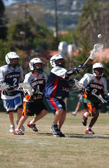 Dragons, Cannons and Outlaws try to win the ball during an L.A.  Lacrosse League clinic. The Dragons beat the Barrage, 7-5, in Sunday's championship game at the Palisades Recreation Center.